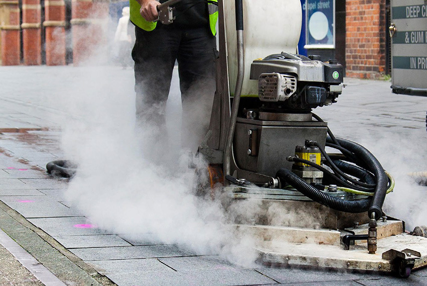 A machine cleaning chewing gum off a pavement
